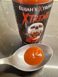 Elijah’s XTreme Regret Hot Sauce on a spoon
